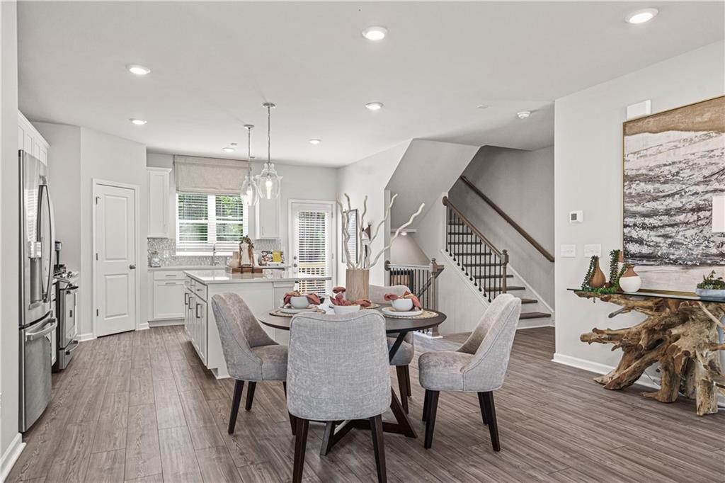 66 Wilder Ridge Way Lawrenceville, GA 30044 - Photo 21 of 44 a dining room with furniture entryway and wooden floor
