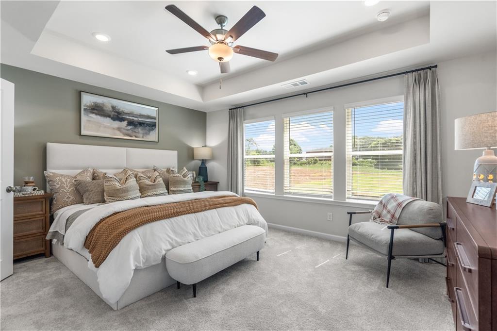 66 Wilder Ridge Way Lawrenceville, GA 30044 - Photo 26 of 44 a spacious bedroom with a large bed and a large window