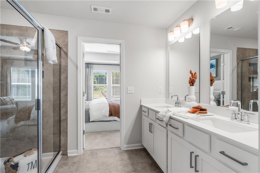 66 Wilder Ridge Way Lawrenceville, GA 30044 - Photo 27 of 44 a bathroom with a double vanity sink mirror and double