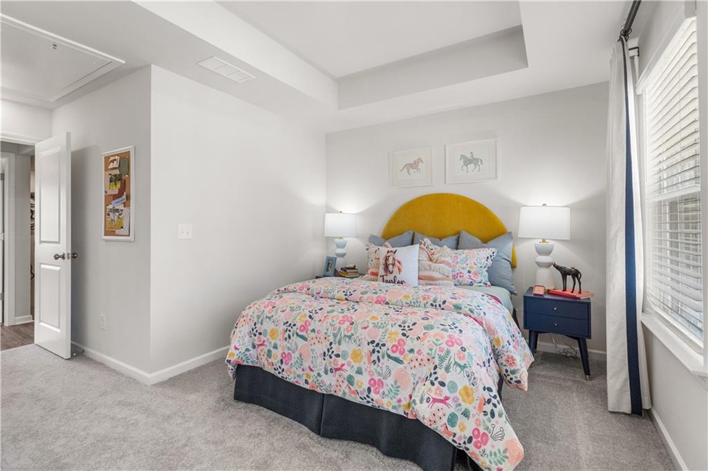 66 Wilder Ridge Way Lawrenceville, GA 30044 - Photo 30 of 44 a bedroom with a bed and a dresser