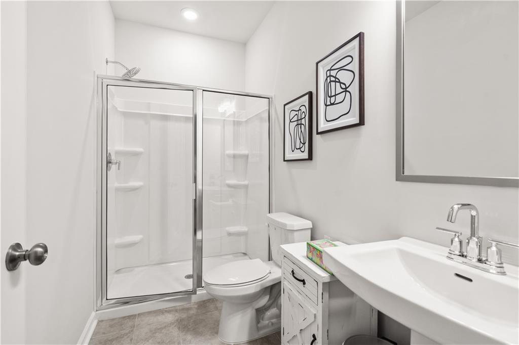 66 Wilder Ridge Way Lawrenceville, GA 30044 - Photo 7 of 44 a bathroom with a sink a toilet and shower