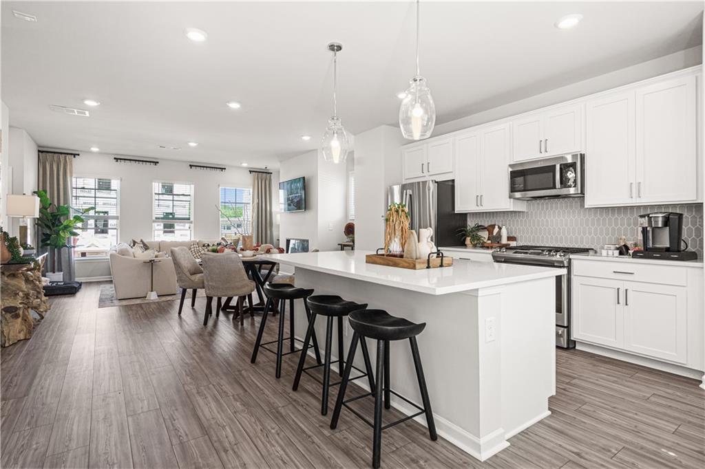 66 Wilder Ridge Way Lawrenceville, GA 30044 - Photo 8 of 44 a kitchen with counter space appliances and a dining table