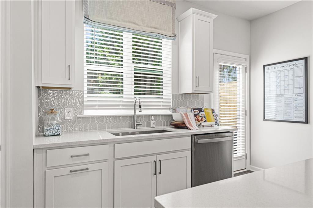 66 Wilder Ridge Way Lawrenceville, GA 30044 - Photo 9 of 44 a kitchen with stainless steel appliances kitchen island a sink a window and cabinets