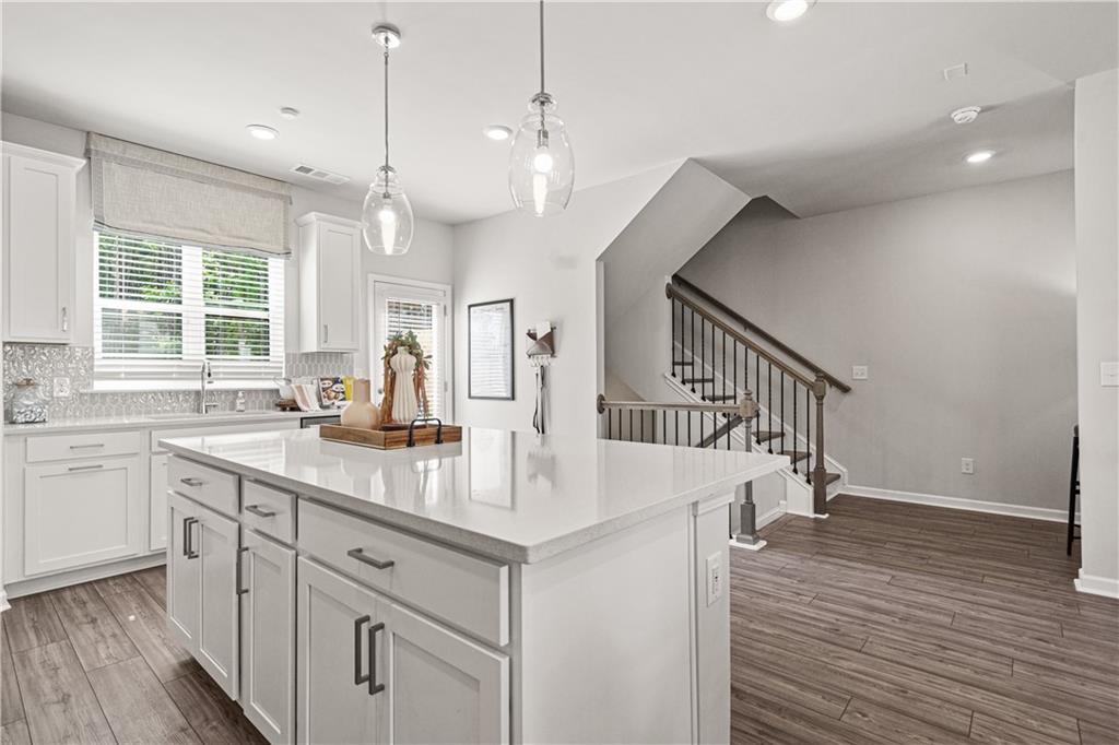 66 Wilder Ridge Way Lawrenceville, GA 30044 - Photo 10 of 44 a kitchen with wooden floor window and cabinets