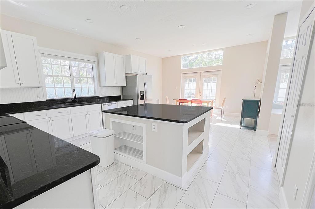 3273 Furlong Way Gotha, FL 34734 - Photo 12 of 38 a kitchen with stainless steel appliances granite countertop a sink and a stove