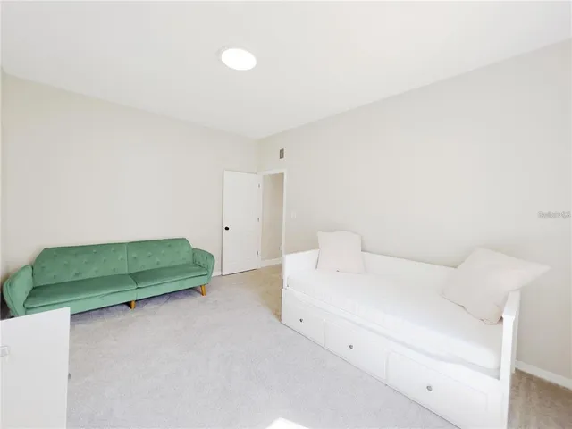 a room with a bed and green walls