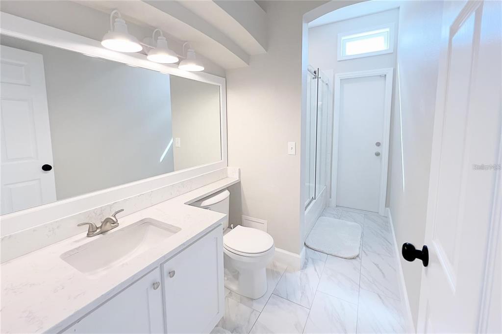 3273 Furlong Way Gotha, FL 34734 - Photo 18 of 38 a bathroom with a sink toilet a mirror and shower