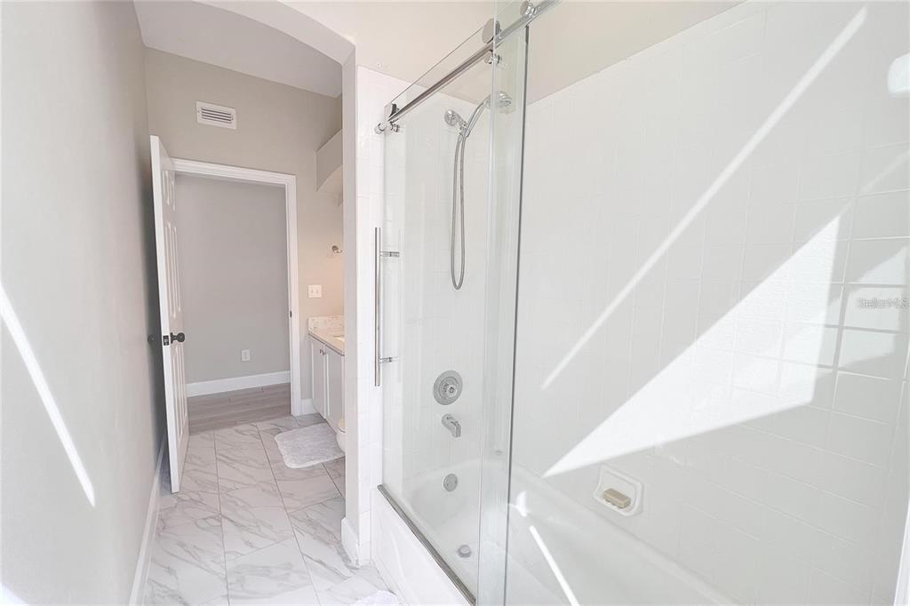 3273 Furlong Way Gotha, FL 34734 - Photo 19 of 38 a bathroom with a shower and a glass door
