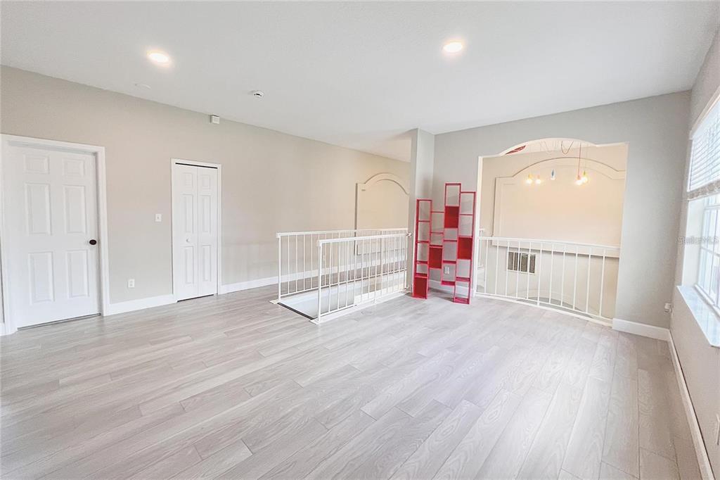 3273 Furlong Way Gotha, FL 34734 - Photo 20 of 38 an empty room with wooden floor and windows