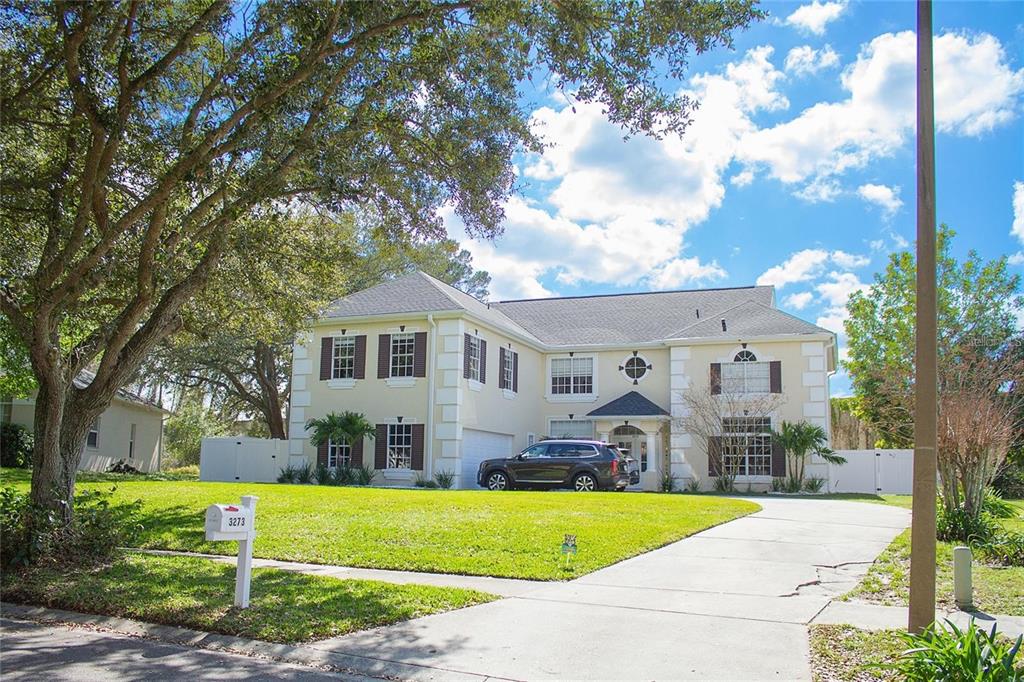 3273 Furlong Way Gotha, FL 34734 - Photo 2 of 38 a front view of a house with a yard and trees