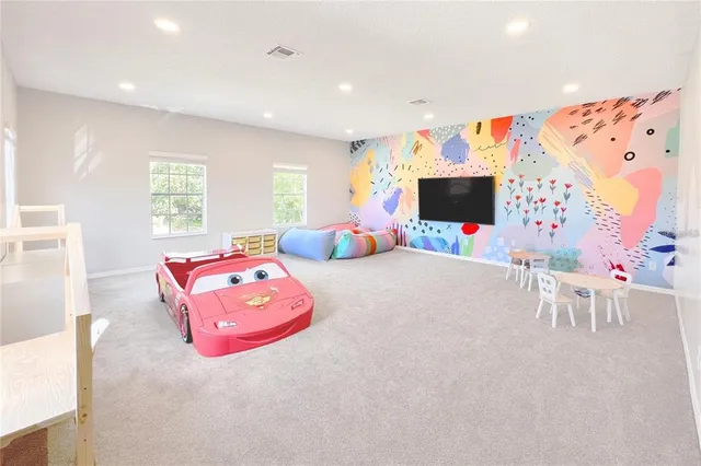 a bedroom with furniture and a flat screen tv