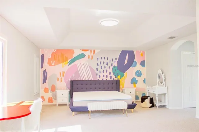 a bedroom with a bed and a couch