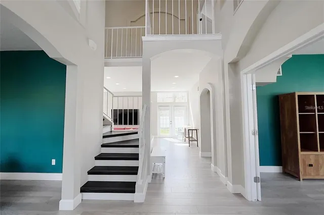 a view of a hallway with wooden floor and entryway