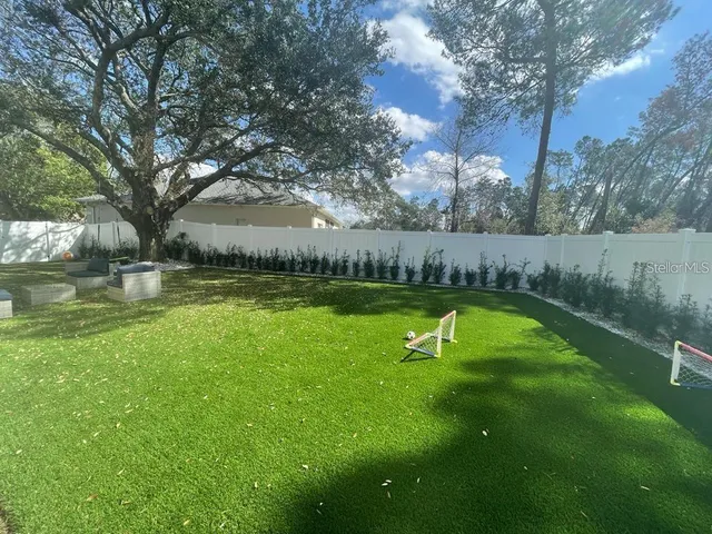 a view of a swimming pool with a yard