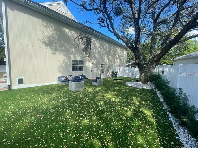a backyard of a house with table and chairs