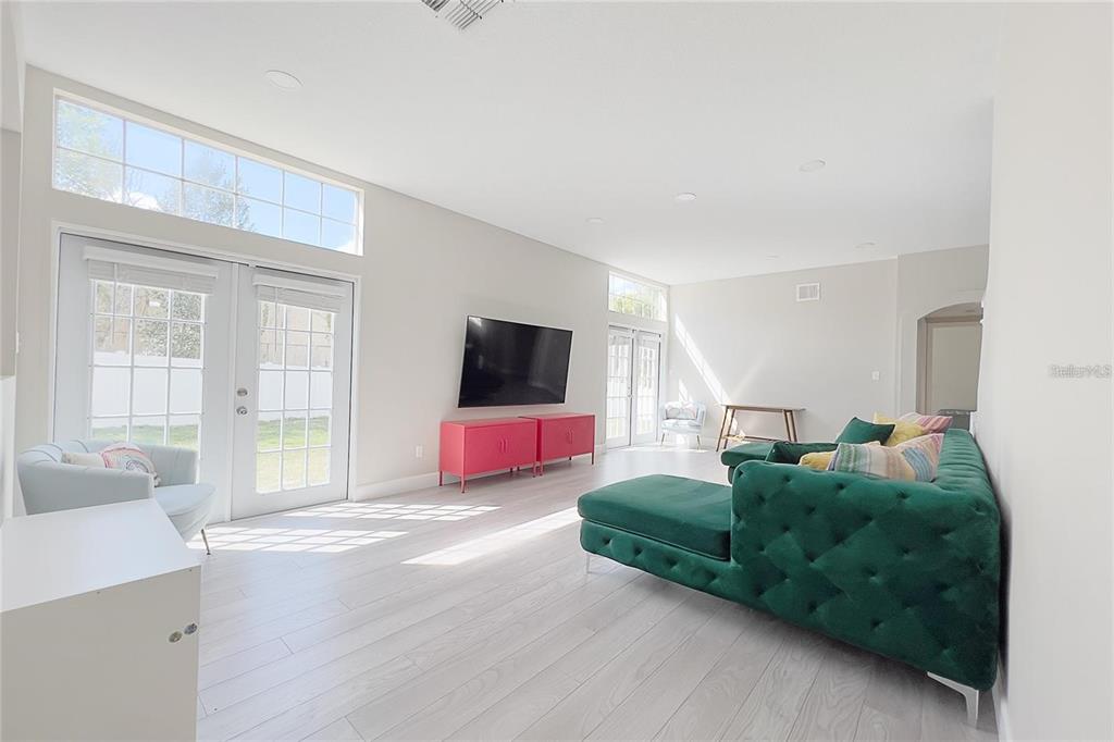 3273 Furlong Way Gotha, FL 34734 - Photo 8 of 38 a spacious bedroom with a bed and a flat screen tv