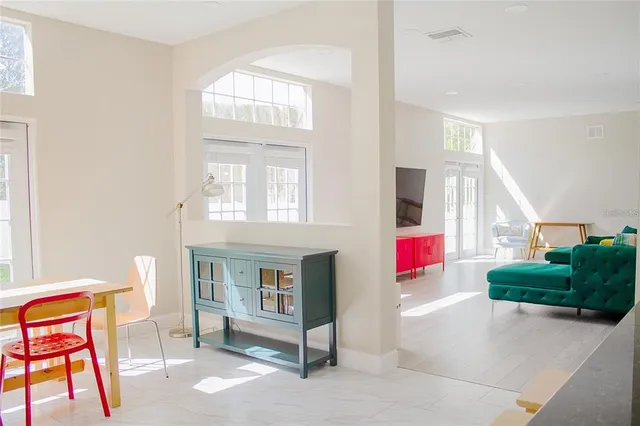 a living room with furniture and a potted plant