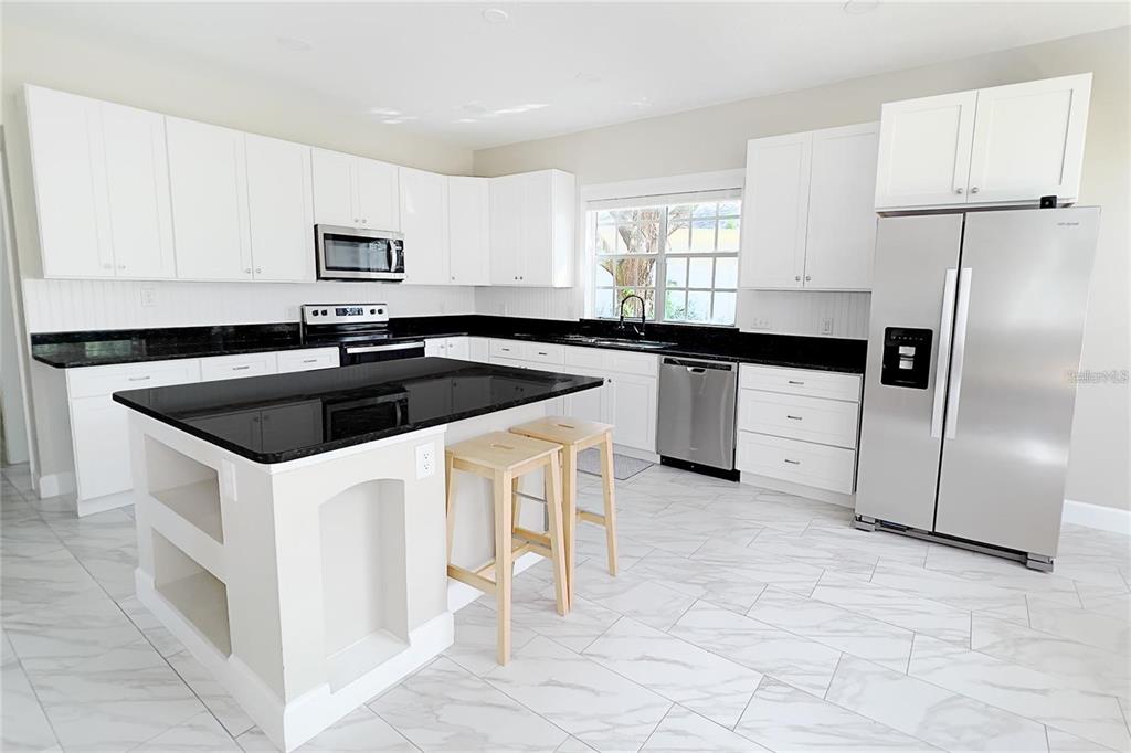 3273 Furlong Way Gotha, FL 34734 - Photo 10 of 38 a kitchen that has a sink cabinets and stainless steel appliances