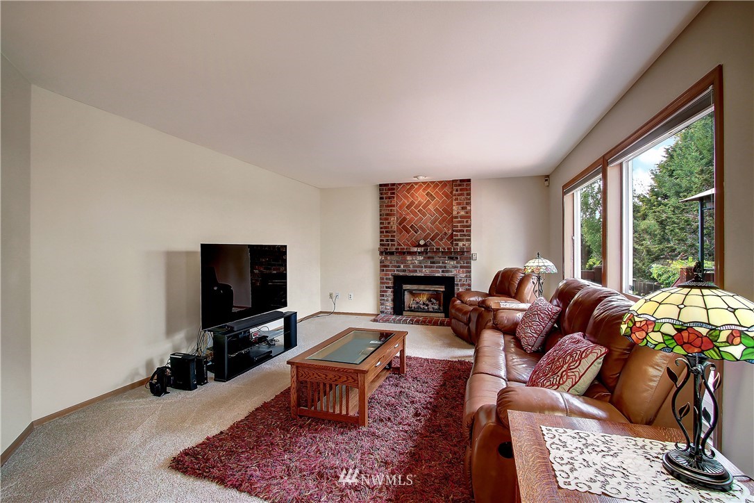 2019 237th Place Southeast Bothell, WA 98021 - Photo 11 of 26 a living room with furniture a rug and a flat screen tv