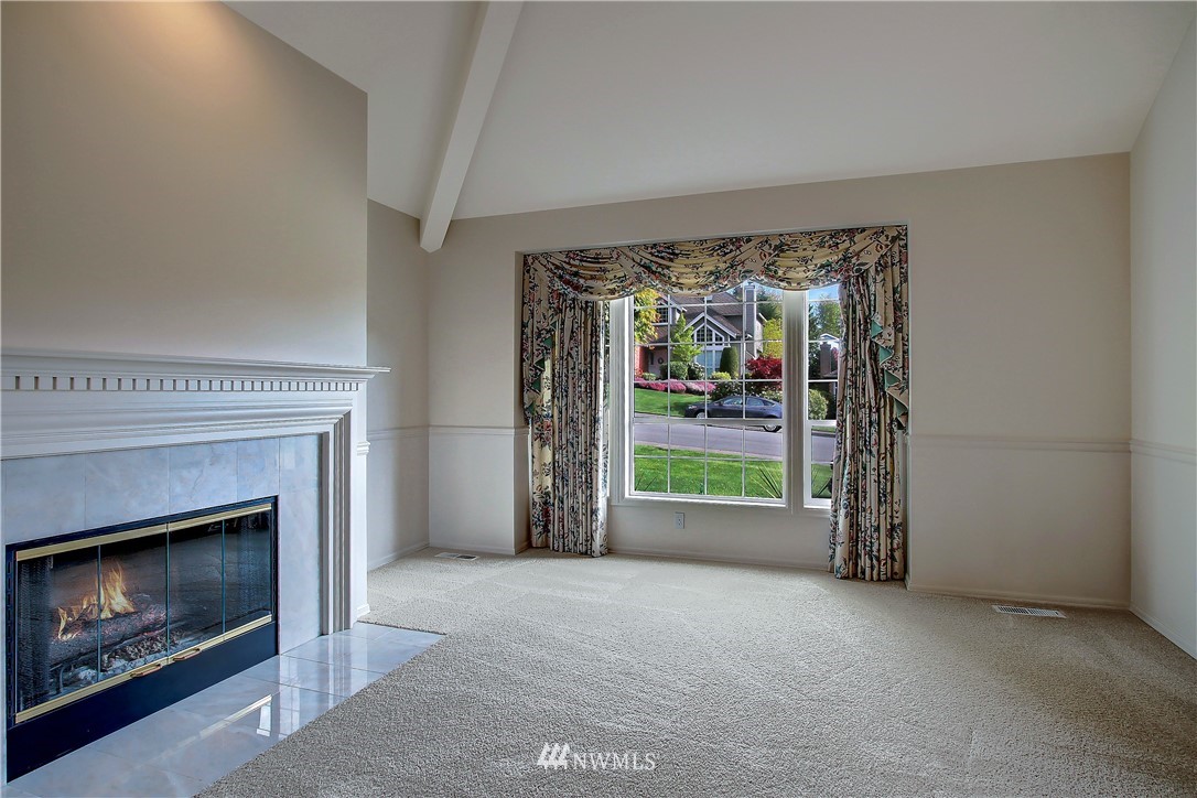 2019 237th Place Southeast Bothell, WA 98021 - Photo 14 of 26 a view of an empty room with floor to ceiling window and fire place
