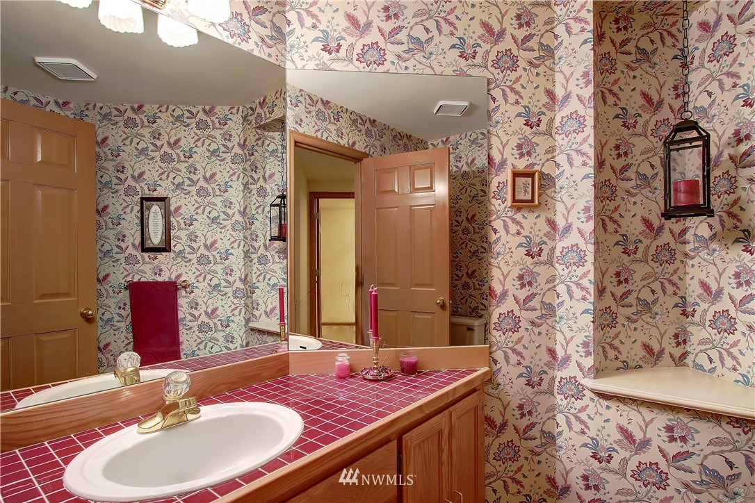 2019 237th Place Southeast Bothell, WA 98021 - Photo 16 of 26 a bathroom with a granite countertop sink a mirror and shower