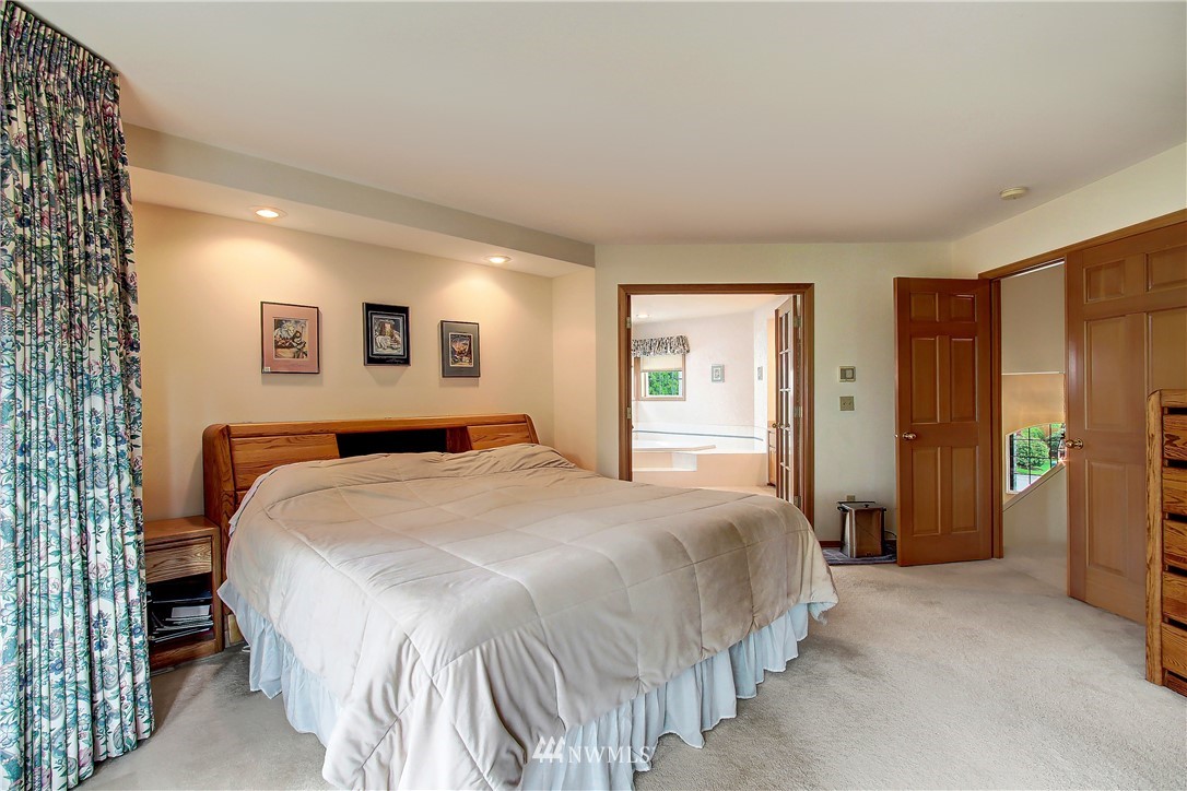 2019 237th Place Southeast Bothell, WA 98021 - Photo 19 of 26 a bedroom with a large bed and a chandelier
