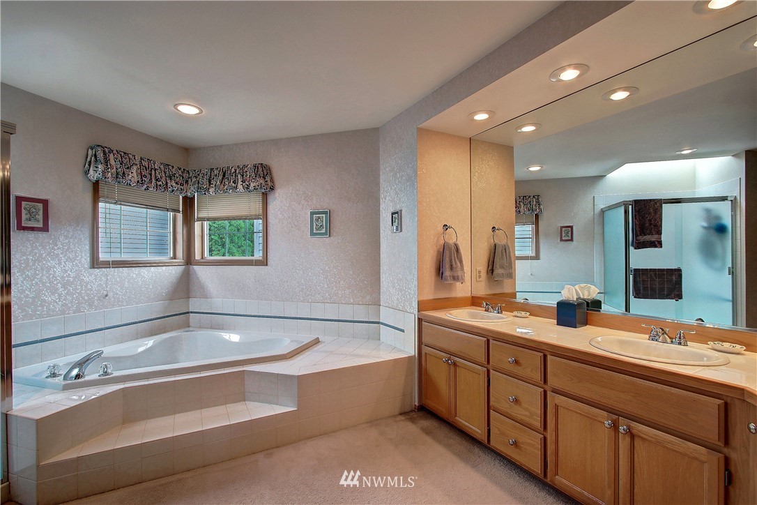 2019 237th Place Southeast Bothell, WA 98021 - Photo 20 of 26 a spacious bathroom with a double vanity sink mirror and bathtub