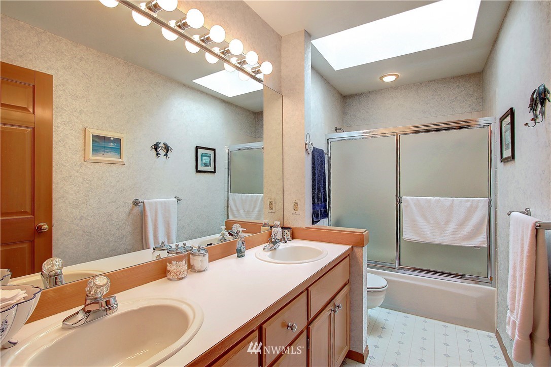 2019 237th Place Southeast Bothell, WA 98021 - Photo 23 of 26 a bathroom with a sink double vanity granite tub and a mirror