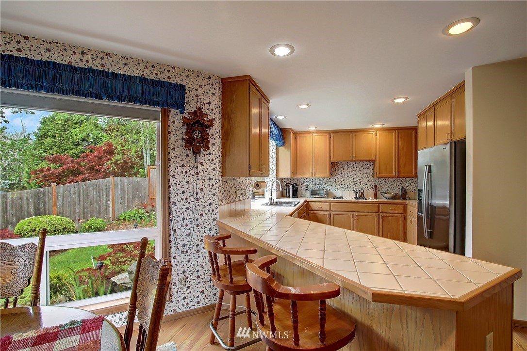 2019 237th Place Southeast Bothell, WA 98021 - Photo 5 of 26 a large kitchen with a table and chairs