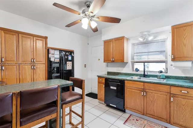 a kitchen with a sink cabinets and window