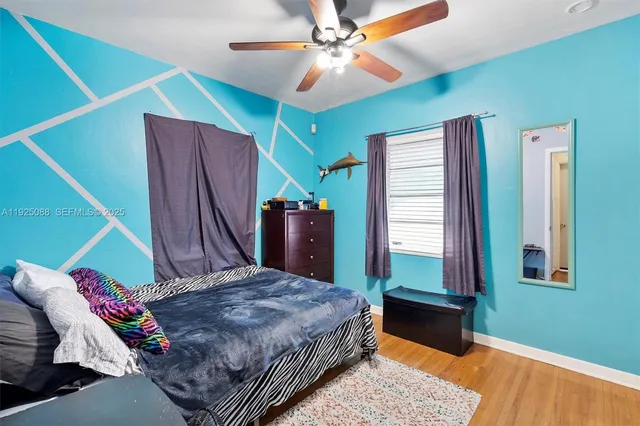 a bedroom with a bed dresser and a window