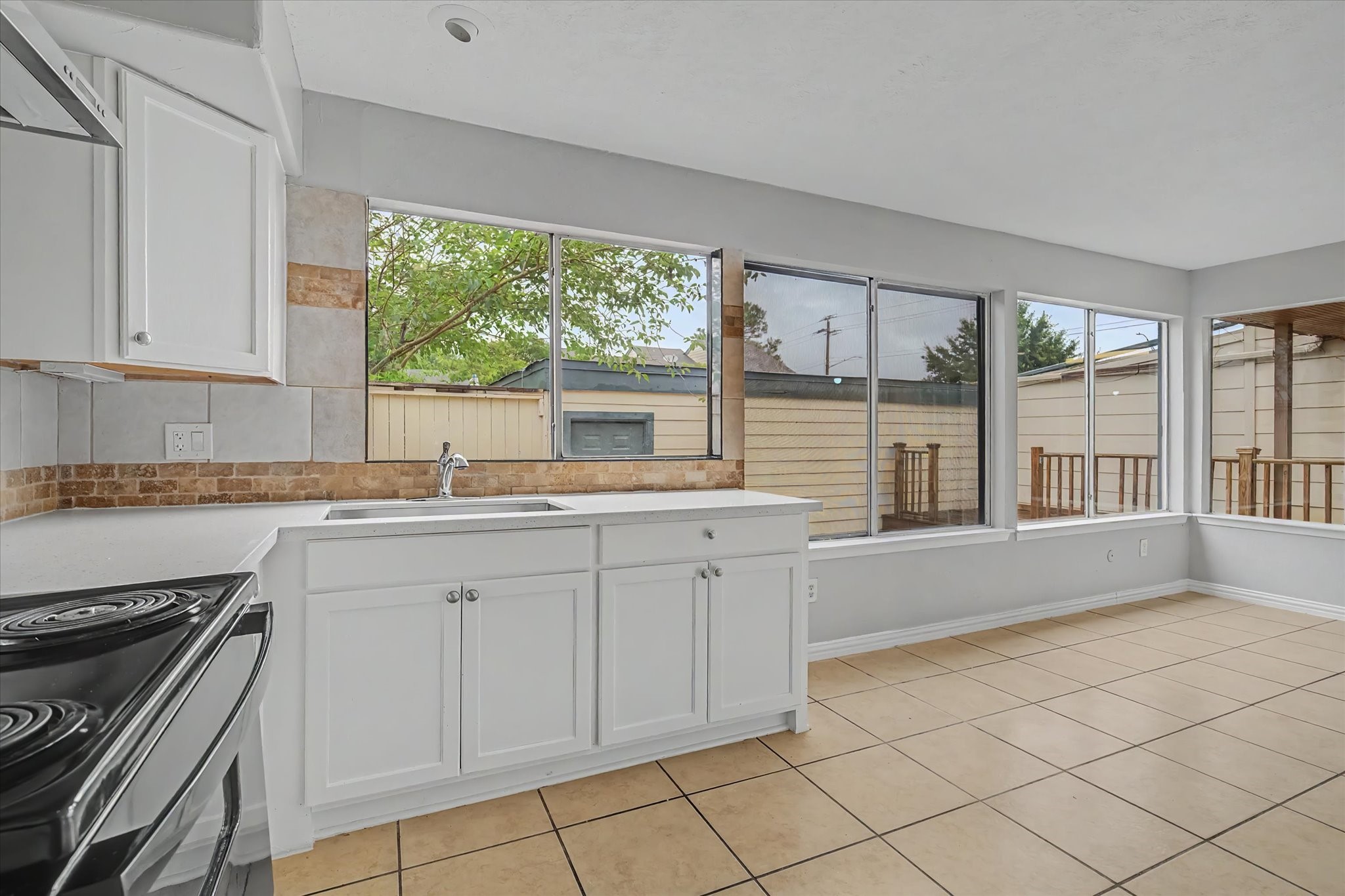 7330 South Dairy Ashford Road Houston, TX 77072 - Photo 11 of 33 a kitchen with granite countertop white cabinets and a large window