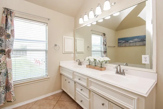 a bathroom with a sink a vanity and a mirror