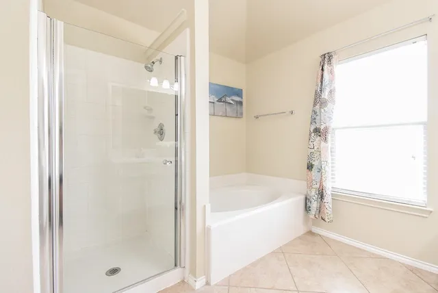 a bathroom with a bathtub and a shower