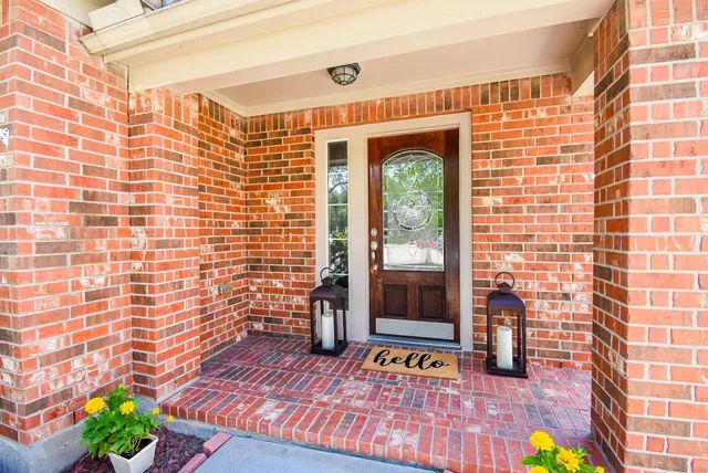 a view of a balcony with wooden floor and a potted plant
