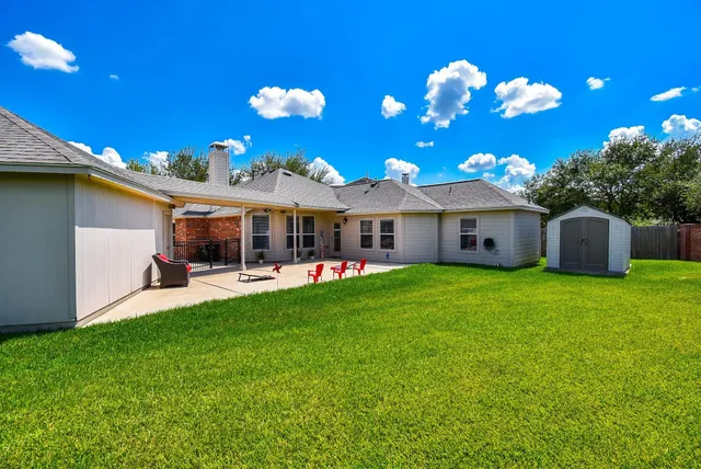 a front view of a house with swimming pool having outdoor seating