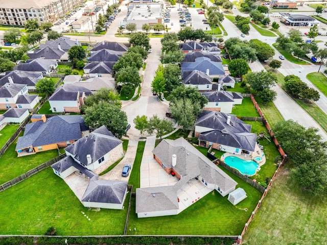 an aerial view of residential house with outdoor space and pool