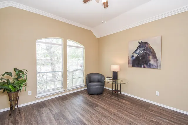 a workspace with wooden floor and a window