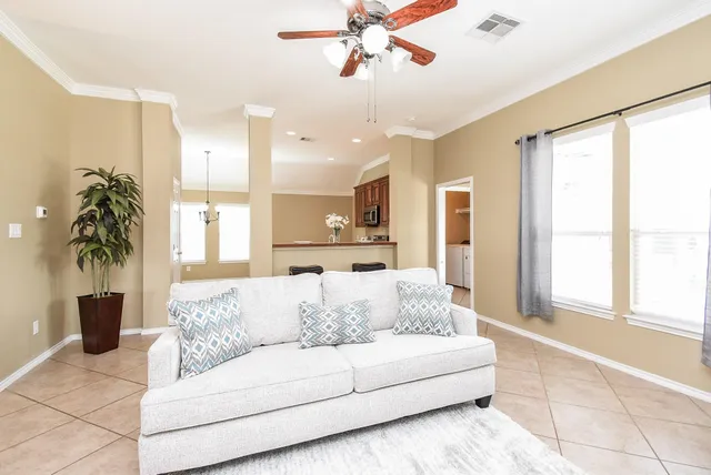 a living room with furniture and a large window