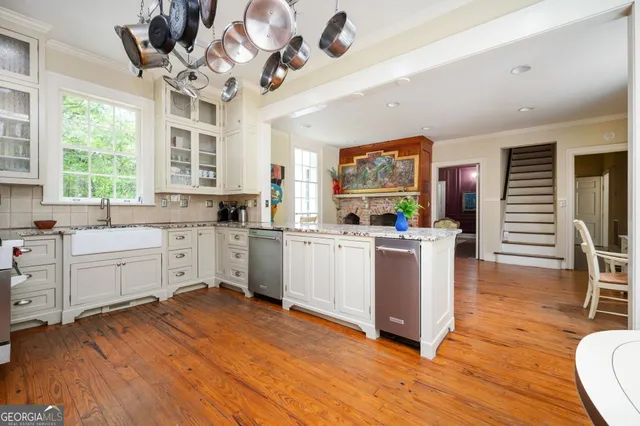 a white bath tub sitting next to a white sink and a mirror