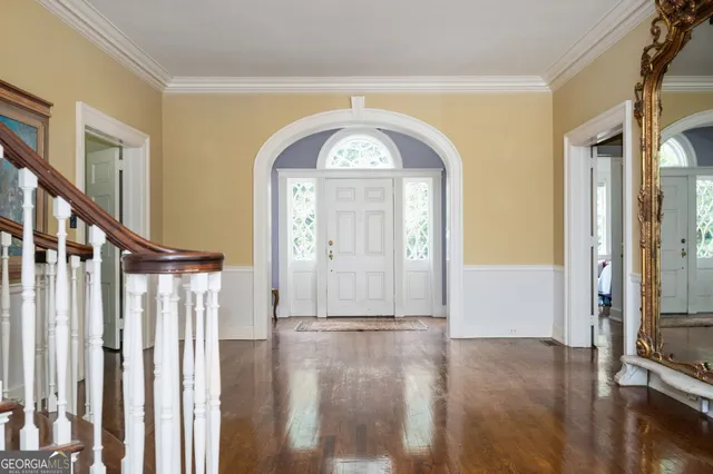 a view of empty room with fireplace and wooden floor