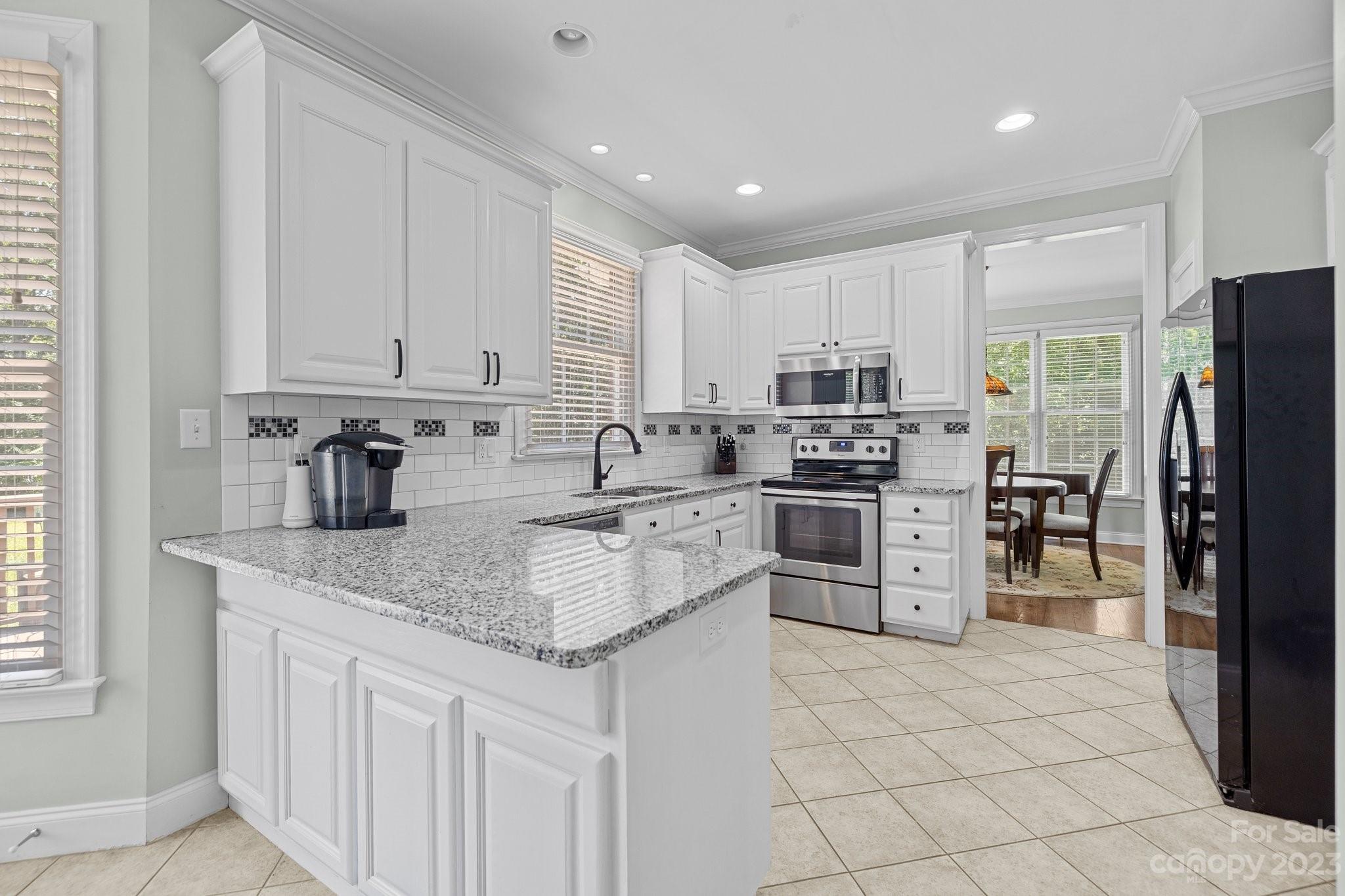 1300 Dutch Road Mount Pleasant, NC 28124 - Photo 13 of 41 a kitchen with stainless steel appliances granite countertop a refrigerator sink and cabinets