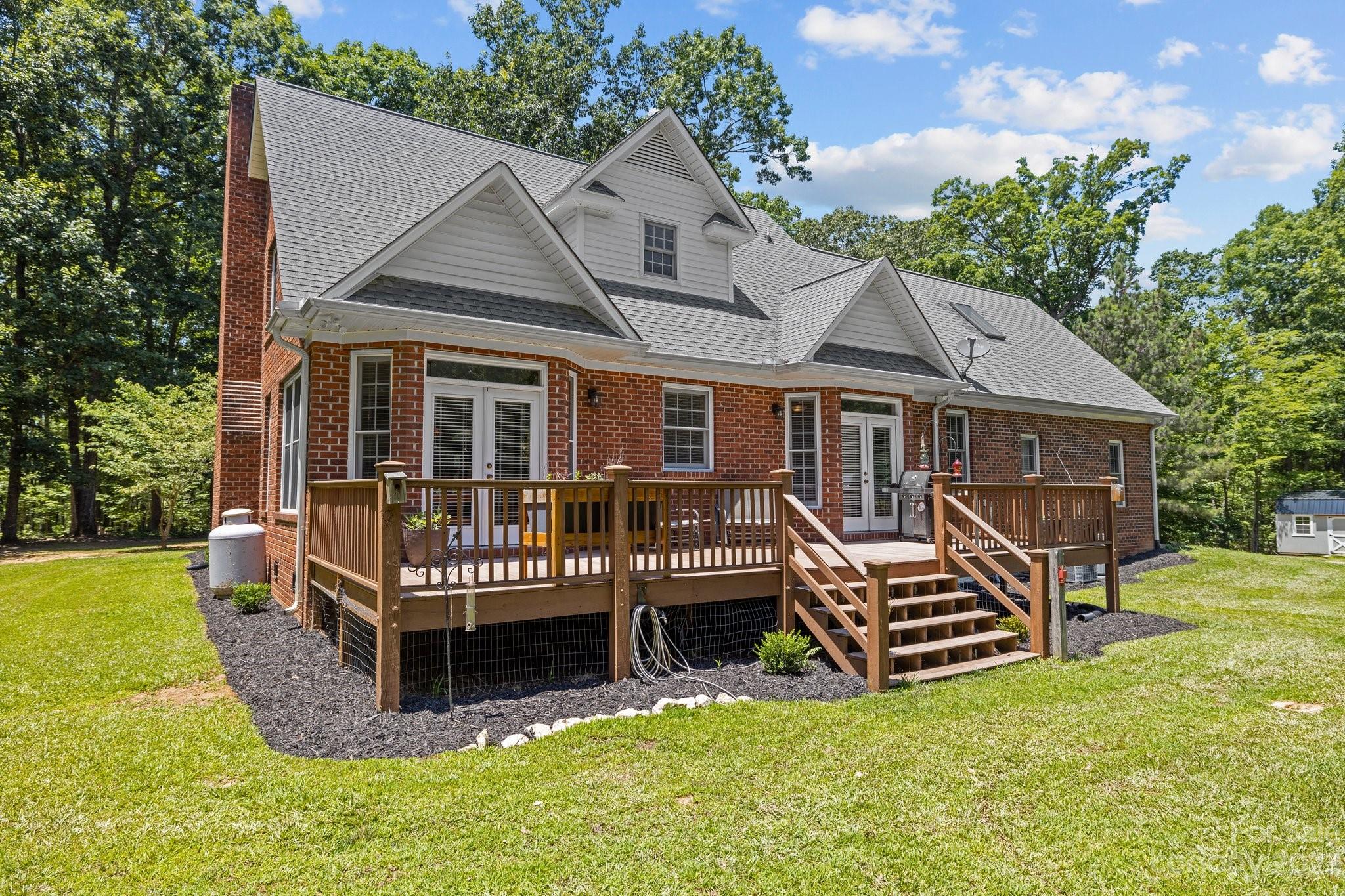 1300 Dutch Road Mount Pleasant, NC 28124 - Photo 5 of 41 a view of a house with a yard and deck wooden floor