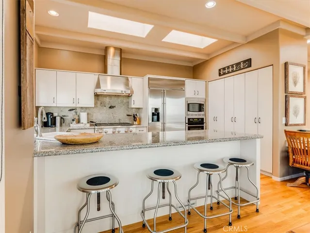 a kitchen with stainless steel appliances granite countertop a stove and a sink