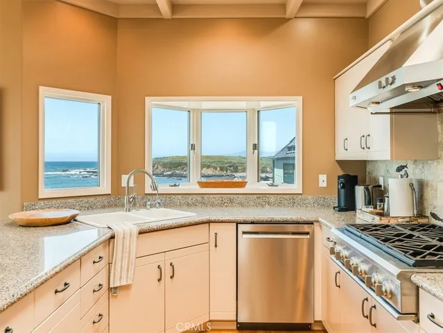 a kitchen with granite countertop a sink and a window