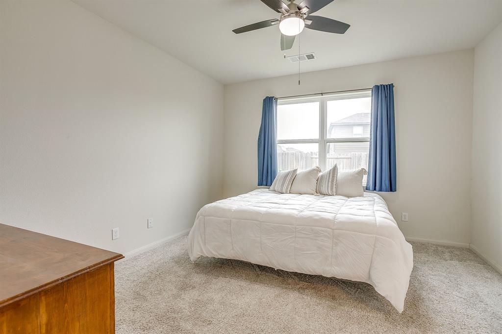 136 Kennedy Drive Venus, TX 76084 - Photo 9 of 27 a bedroom with a bed and window