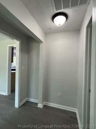 an empty room with a chair and closet