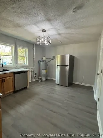 a view of a kitchen with a sink dishwasher and a refrigerator