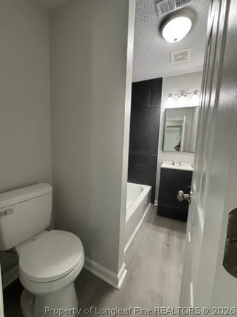 a bathroom with a toilet and a sink