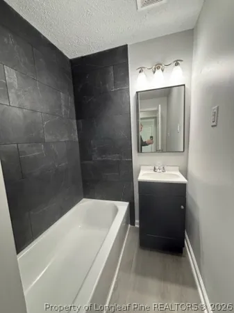 a bathroom with a bathtub and a sink